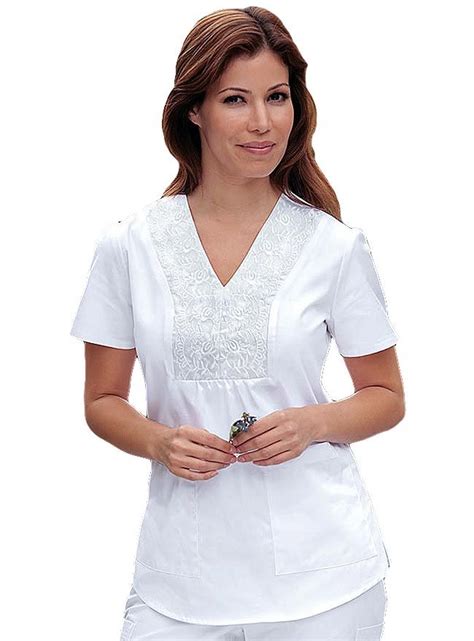 Look stylish with this embroidered scrub top from Barco Prima. This v ...