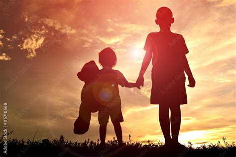 Silhouette children playing on sunset Stock Photo | Adobe Stock