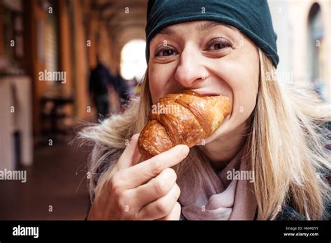 woman bite croissant outdoor bar breakfast Stock Photo - Alamy