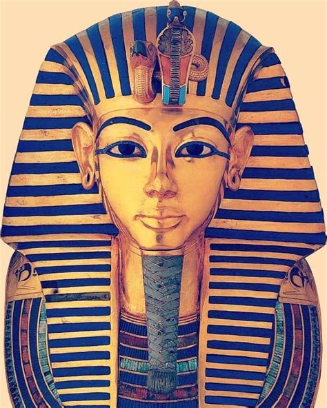 an ancient egyptian mask with blue and gold stripes