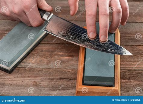 Man Sharpening a Chef`s Knife with Damascus Steel Stock Photo - Image ...