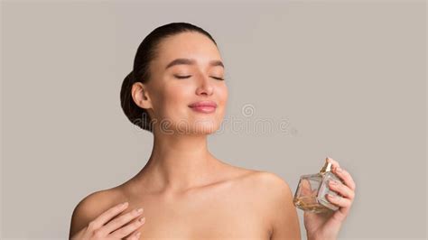 Girl Spraying Fresh Perfume on Her Neck and Enjoying Smell Stock Image ...