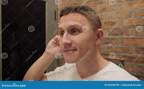 A Man with a Smile on His Face Cleans His Ears with an Ear Stick. Stock Footage - Video of ...