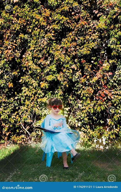 Little Girl Sitting in a Garden Stock Image - Image of little, girl: 176291121