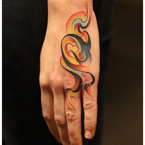 Abstract colorful smoke tattoo on the hand - Tattoogrid.net