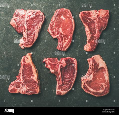 Flat-lay of raw beef meat steak cuts over black background Stock Photo - Alamy