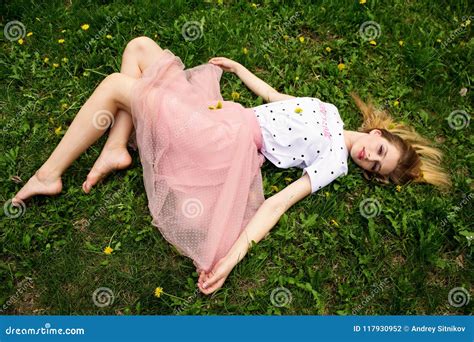 Barefoot Girl Resting on the Grass. Stock Photo - Image of attractive, horizontal: 117930952