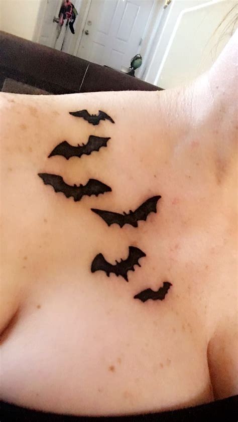 a woman's chest with black bats on it