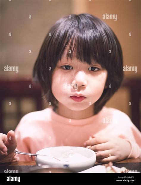Close-up Portrait Of Cute Boy Standing By Dining Table Stock Photo - Alamy