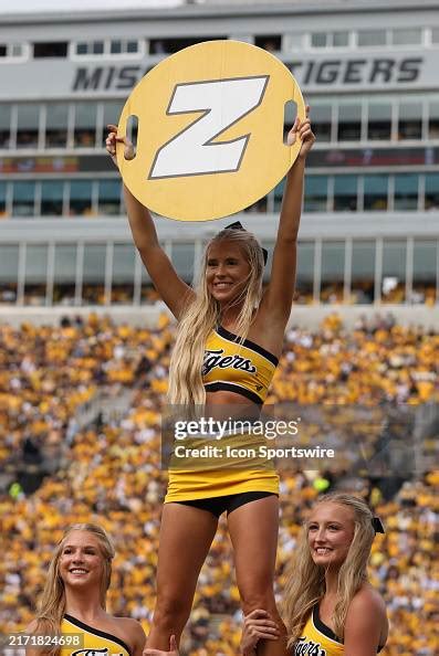 A Missouri Tigers cheerleader performs during a college football game ...