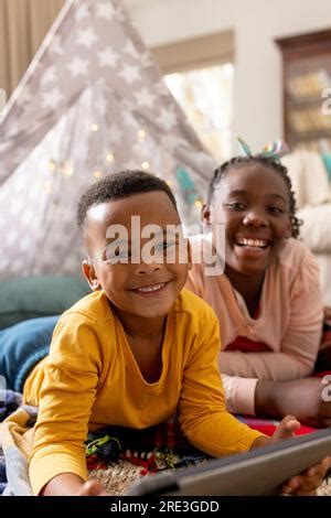 Its our tablet time. a little brother and sister using a digital tablet
