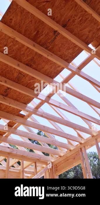 Wooden roof trusses and framing during building construction, showing ...