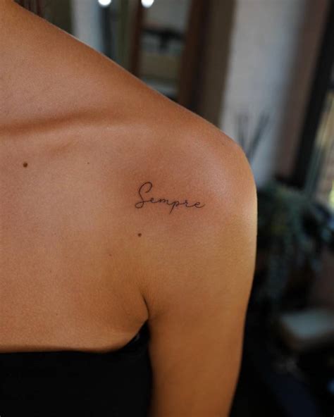 Tattoo of the word "sempre" located on the shoulder.