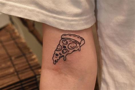 Pizza slice tattoo on the bicep.