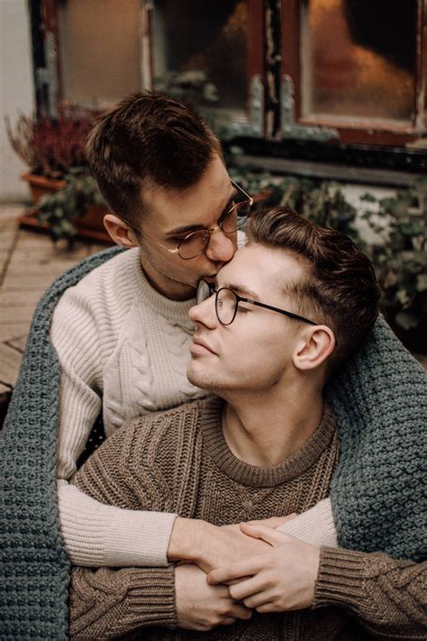 Download Gay Couple Cuddling With Blanket Wallpaper | Wallpapers.com