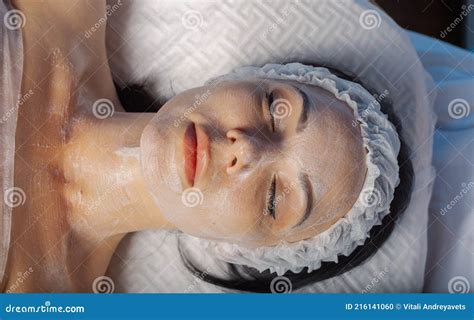 beautiful young woman  cream mask  face stock photo image
