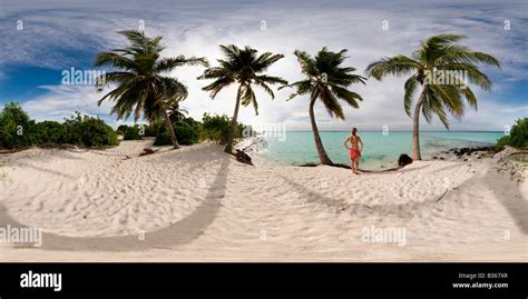 360 degree panoramic view of young woman looking out to sea on a ...