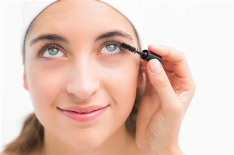 premium photo hand applying mascara  beautiful woman