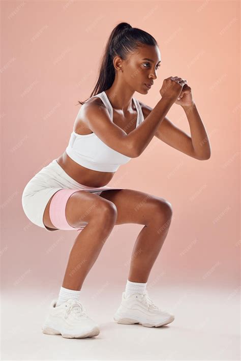 Squat exercise and fit female athlete in a training workout for glutes
