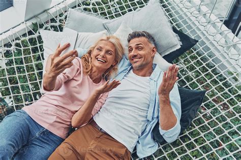 Top view of beautiful mature couple making selfie by smart phone and