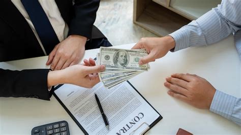 Premium Photo | Midsection of man bribing businessman in office