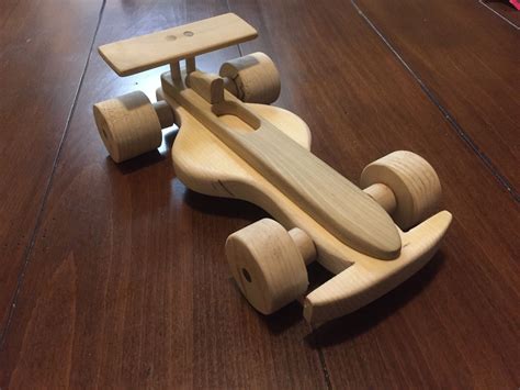 Wooden Toy Car on Hardwood Floor