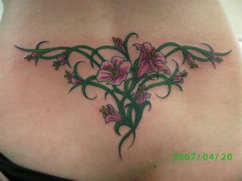 flowers lower back tattoo | Lower back tattoos, Rose tattoos for women ...