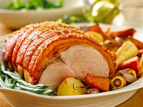 Roast pork leg with crackling, roasted vegetables and apple sauce