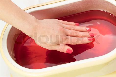 Process paraffin treatment of female hands in beauty salon | Stock ...