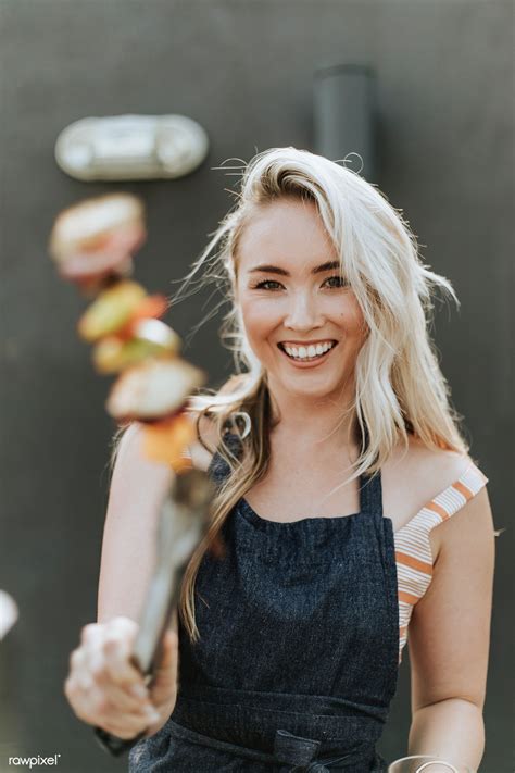 Download premium image of Cheerful woman cooking a barbeque skewer ...