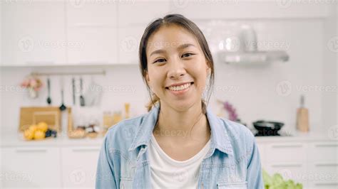 Portrait of young Asian Latin woman feeling happy smiling at home