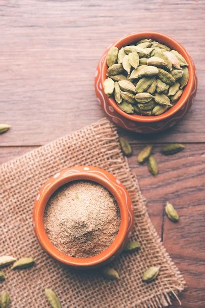 Premium Photo | Elaichi or cardamom powder in bowl or heap over moody ... 