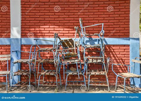 Pile Of Broken Chairs Outside A Classroom In A Public School In ...