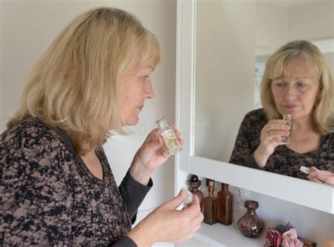 Middle-aged Woman Smelling Perfume. Stock Photo - Image of aged ...