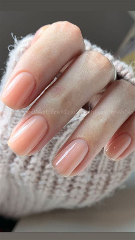 a woman's hand with pink manies and a ring on her thumbnail