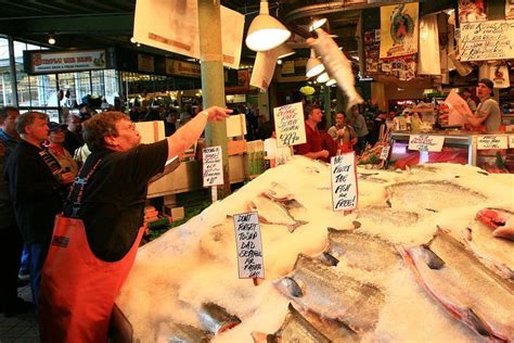 Low flying fish at Pike Place Fish Market; photograph by Adam Grim ...