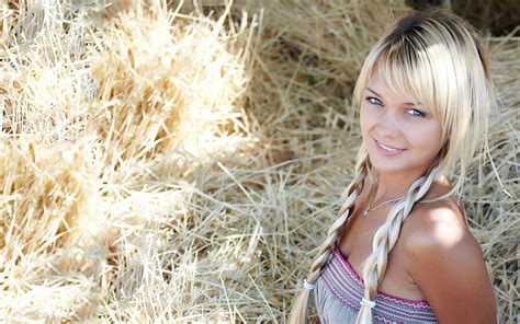 Download Blonde Woman On A Bed Of Hay Wallpaper | Wallpapers.com
