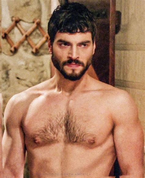 a shirtless man standing in front of a mirror