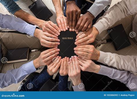 Hands Holding Holy Bible stock photo. Image of group - 103306592