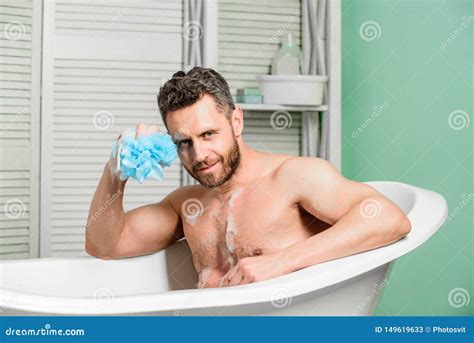 pampering  beauty routine handsome muscular man relaxing bathtub