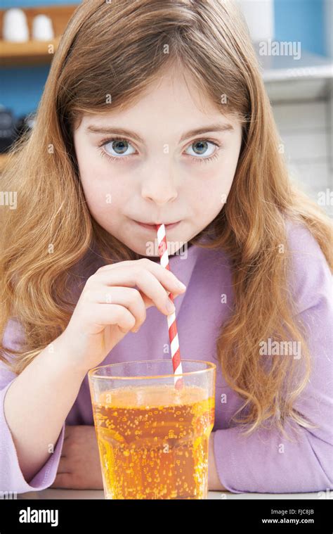 young girl drinking glass  soda  straw stock photo alamy
