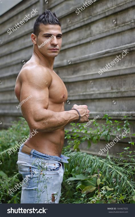 muscular young latino man shirtless jeans  shutterstock