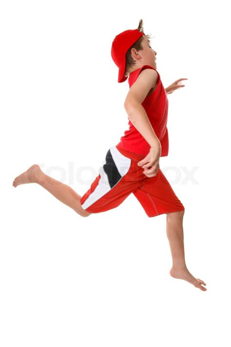 A boy running or sprinting with large open strides in a hurryor just ...