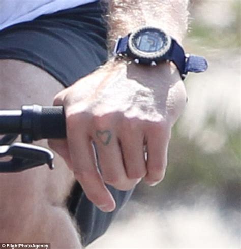 Chris Martin unveils tattoo on his knuckle while cycling in Malibu
