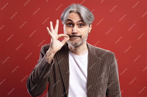 premium photo man making mouth closed sign