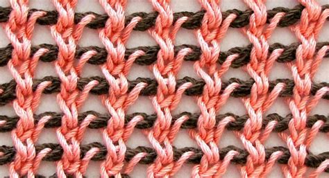 an orange and brown crochet pattern on a white surface