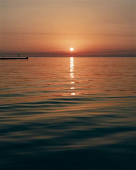 Photo of a Calm Sea during Sunset · Free Stock Photo