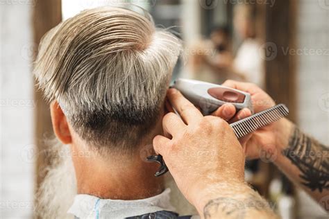 hairdresser making stylish haircut   man  stock photo