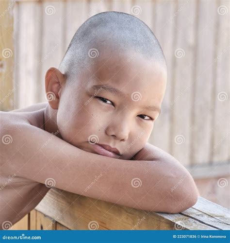 Portrait of Tanned Asian Boy, Hair Cut Bald, Looking at Camera Stock