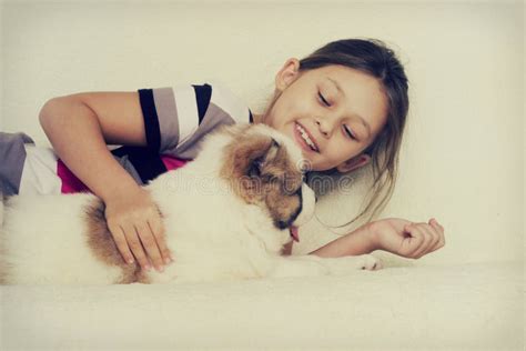 Child hugging a puppy stock photo. Image of smiling, person - 48261060